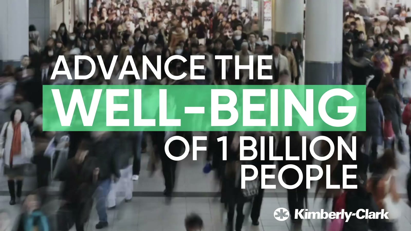 A crowd crossing a street, with the words Advance the well-being of 1 billion people