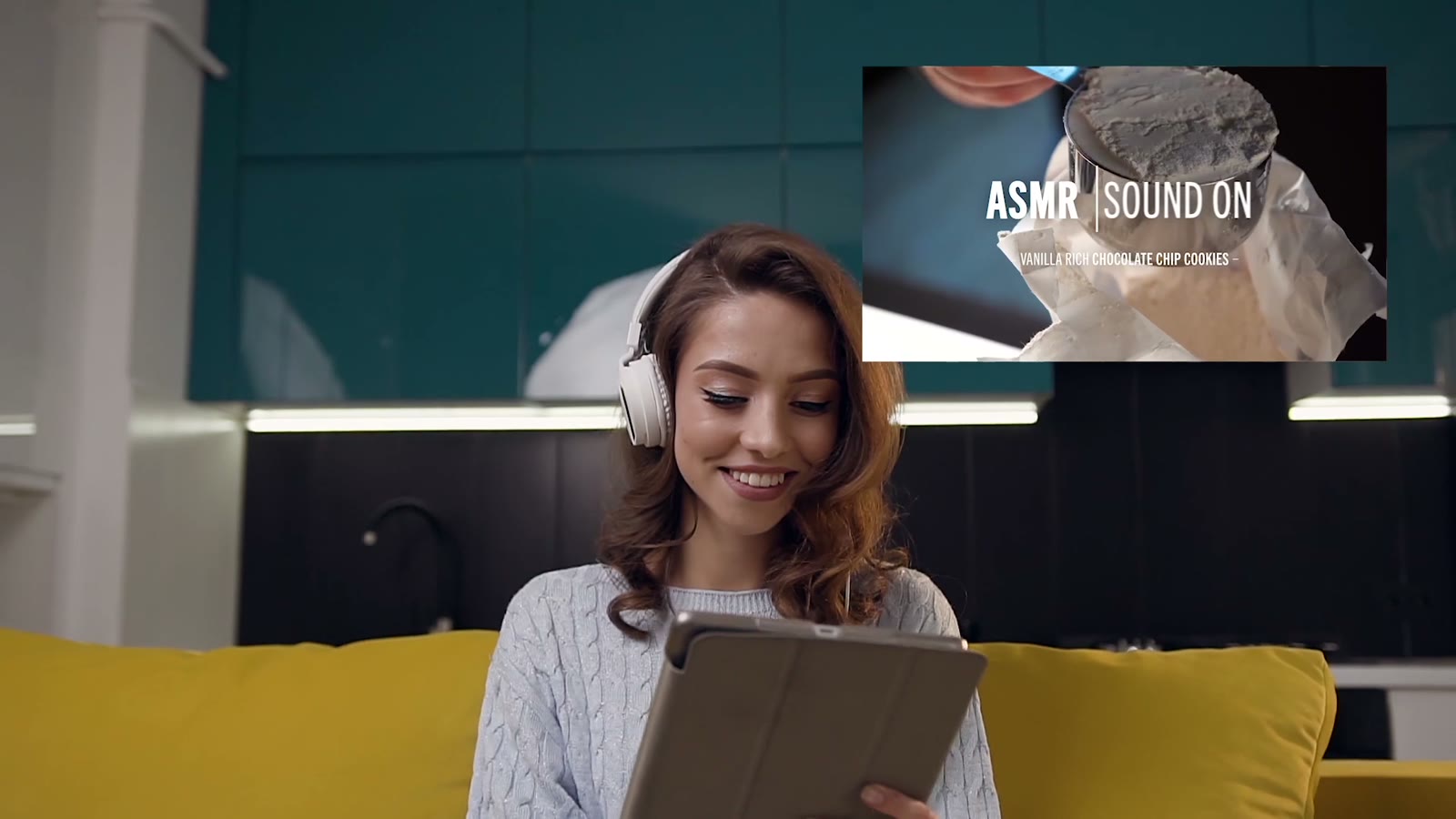 A woman in headphones watching an ASMR recipe on a tablet